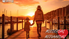 Mother and daughter holding hands walking along a pier at sunset